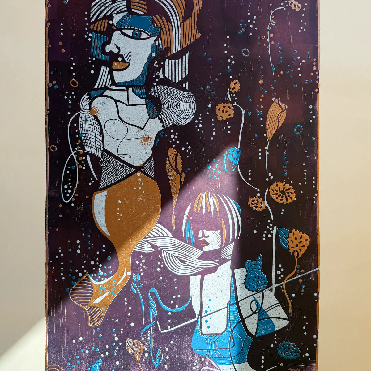 Detail from the linocut Underwater Love. It shows the reflection of sunlight on the artwork and how the colors begin to glow as a result.