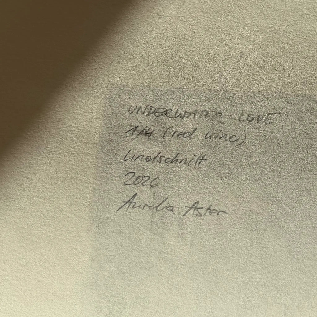 Information about the artwork and the signature, written in pencil on the back of the linocut: Underwater Love, 1/4 (red wine), linocut, 2026, Aurelia Astor