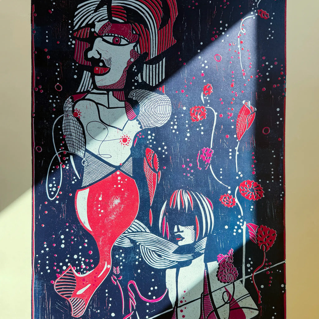 Detail from the linocut Underwater Love. It shows the reflection of sunlight on the artwork and how the colors begin to glow as a result.