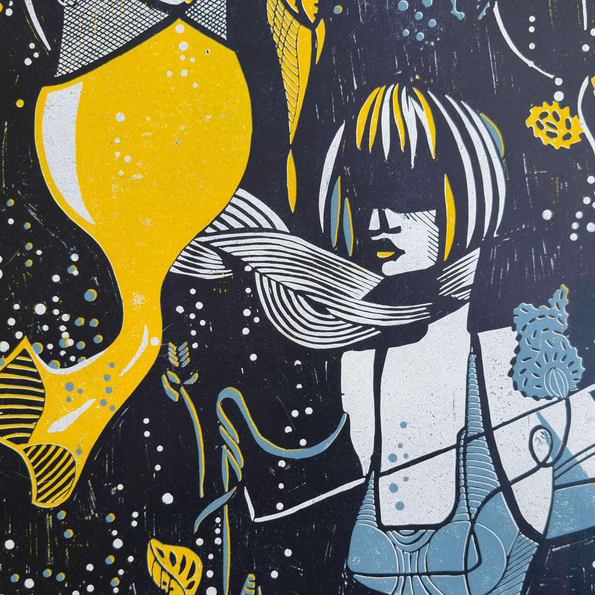Detail from the linocut Underwater Love. It depicts a figurative female figure in yellow, blue and white, wearing a blindfold and a scarf, and surrounded by aquatic plants.
