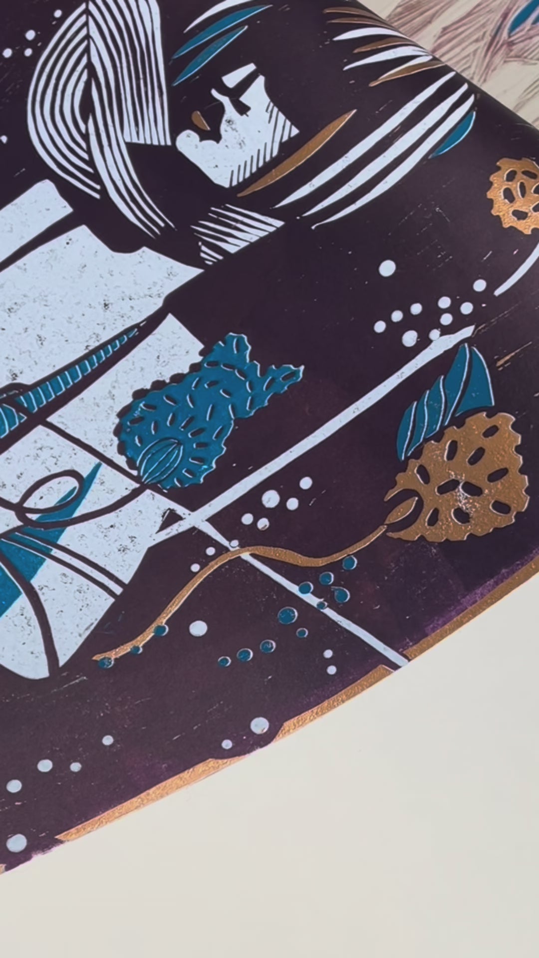 Paper is peeled off the linoleum printing block and shows close-ups of the linoleum print “Underwater Love copper/blue.”